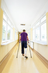 Man walks on crutches after arthroscopic surgery