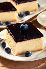 Cheesecake with blueberries and a cap of coffee