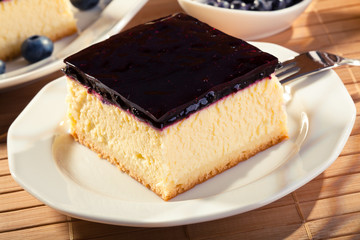 Cheesecake with blueberries and a cap of coffee