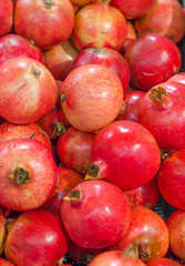 Lot of red fresh pomegranates closeup view