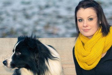 Beautiful young woman with best dog friend in winter