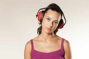 beautiful young brunette posing with anti loud headset