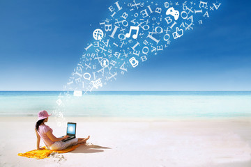 Asian woman relaxing at beach with flying alphabet