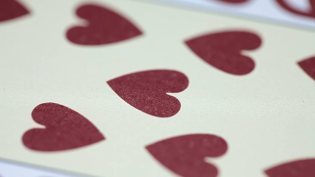 Nine of Hearts playing card rotates on white background