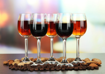 Glasses of liquors with almonds and coffee grains,