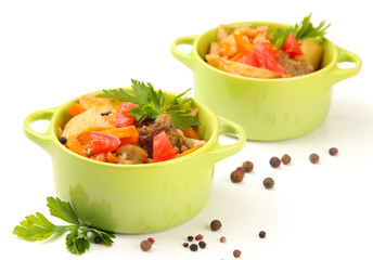 Homemade beef stir fry with vegetables in color pans, isolated