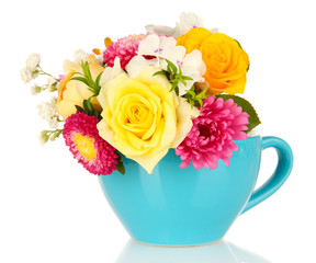 Beautiful bouquet of bright flowers in color mug, isolated