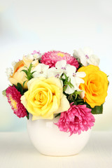 Beautiful bouquet of bright flowers in color vase,