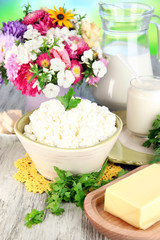 Fototapeta na wymiar Fresh cottage cheese with greens on wooden table close-up