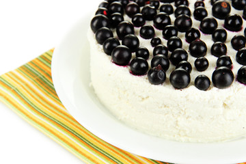 Cheesecake with fresh berries on white plate closeup