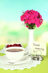 Beautiful bouquet of phlox with cup of tea