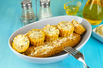 Flavored boiled corn on  plate on wooden table close-up