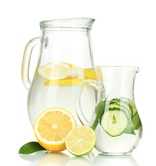 Cold water with lemon, cucumber and ice in pitchers isolated