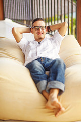 Fototapeta premium man on soft armchair in interior at home