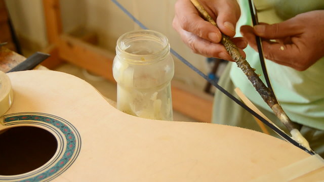 Luthier decorates a flamenco guitar
