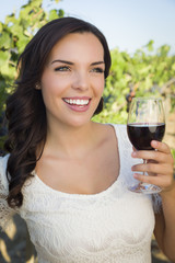 Young Adult Woman Enjoying A Glass of Wine in Vineyard