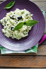 risotto with vegetables and basil, top view