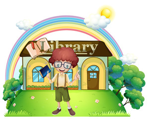 A boy in front of the library in the hilltop