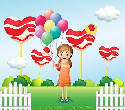 A girl in the candyland with eight balloons