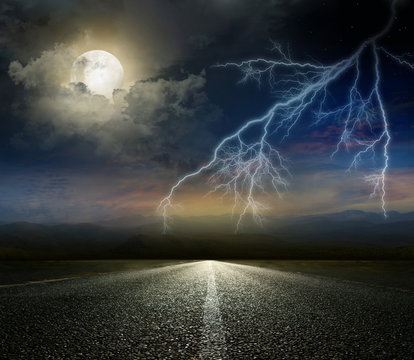moon and lightning above the road