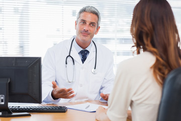 Smiling doctor talking with his patient