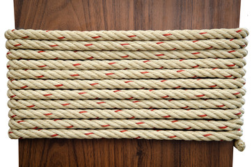 Fototapeta na wymiar Stack of Rope on Brown wood with white background