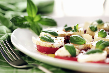 Fresh caprese salad with delicious tomatos + mozzarella and bas