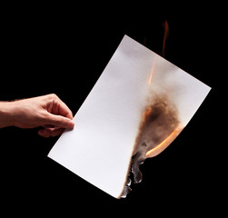 Man hand holding white burned paper