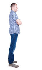 Fototapeta premium Back view of handsome man in shirt looking up.