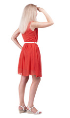 back view of standing young beautiful  blonde woman.