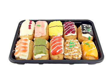 Sushi color Donuts in the black dish.