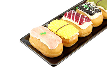 Sushi Donuts in the black dish on white background.