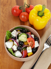 fresh greek salad in clay bowl