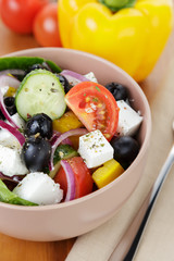 fresh greek salad in clay bowl