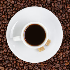 cup of coffee in coffee beans