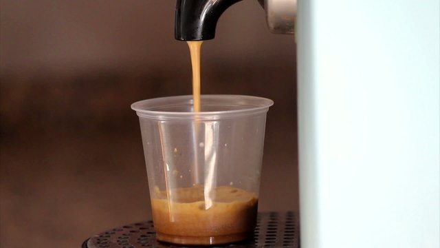 Home expresso machine taking coffee