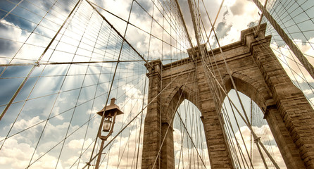 Fototapeta premium Brooklyn Bridge, New York City. Upward view with beautiful sky c