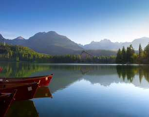 Red boats in mountain lake in High Tatra. Strbske pleso, Slovaki