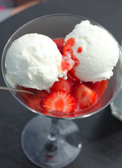 Vanilla ice cream with strawberry sauce in the glass