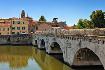 Fototapeta premium Historical roman Tiberius' bridge over Marecchia river in Rimini
