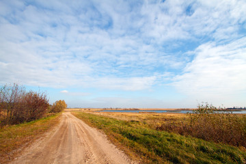 Fototapeta na wymiar Autumn landscape with a road and river