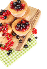 Tasty muffins with berries isolated on white