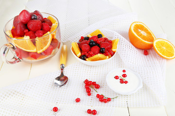 Useful fruit salad in glass cup and bowl