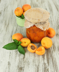 Apricot jam in glass jar and fresh apricots,