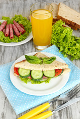 Composition with fruit juice and tasty sandwich with salami