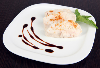 Boiled chicken meat with paprika and sauce, on wooden