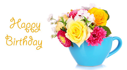 Beautiful bouquet of bright flowers in color mug, isolated