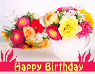 Beautiful bouquet of bright flowers in color mug,