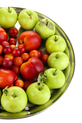 Assortment of juicy fruits on plate, isolated on white