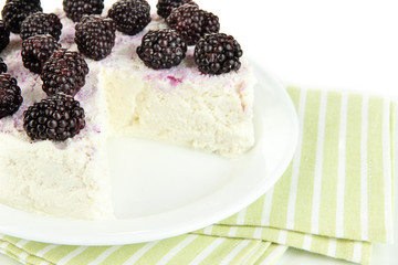 Cheesecake with fresh berries on white plate closeup